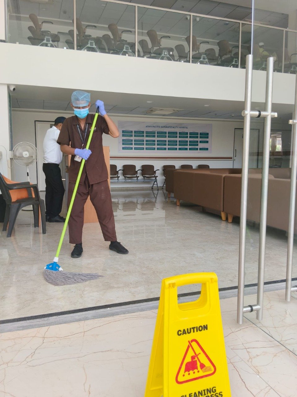 Housekeeping staff cleaning hospital lobby